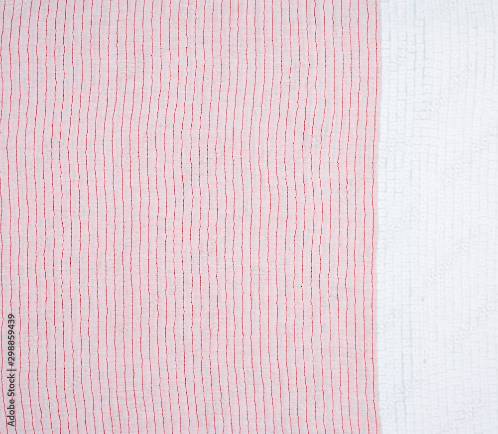 Aufkleber reverse side with a stitching of a red thread of fabric with embroidery with multi-colored sequins