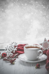 Winter cozy hot chocolate in front of window, snow, sweater. Lazy weekend, love, comfort