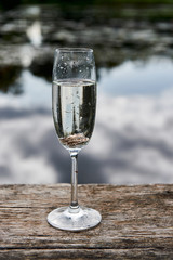 Gold wedding rings in a a glass of champagne.