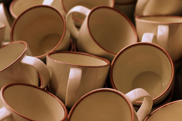 Many cups of cream colored coffee were scattered and cleaned.
