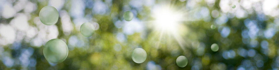 Image of green stylized balls on a beautiful abstract blurred natural background
