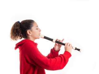 teenage girl playing a recorder or flute © Novodiastock