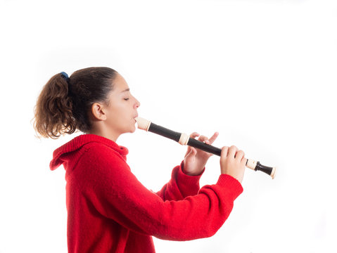 teenage girl playing a recorder or flute