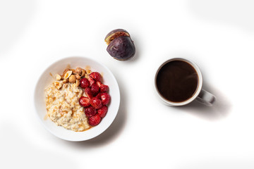 Breakfast oatmeal porridge with fruits berries and coffee cup. Healthy breakfast concept.