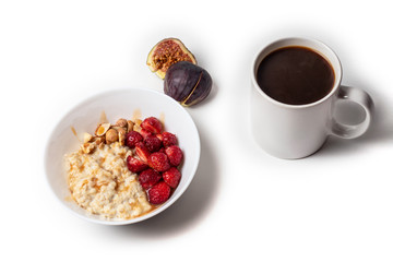 Breakfast oatmeal porridge with fruits berries and coffee cup. Healthy breakfast concept.