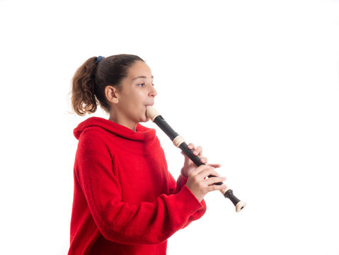 teenage girl playing the recorder