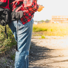 Man with a backpack, view from the back, hiking route in nature and the city, active lifestyle.