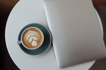 laptop and cup of coffee on the table