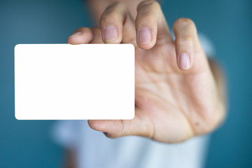 Hand holding  a blank piece of paper. Close up  white business card.