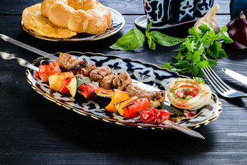 grilled lamb and vegetables kebab close-up
