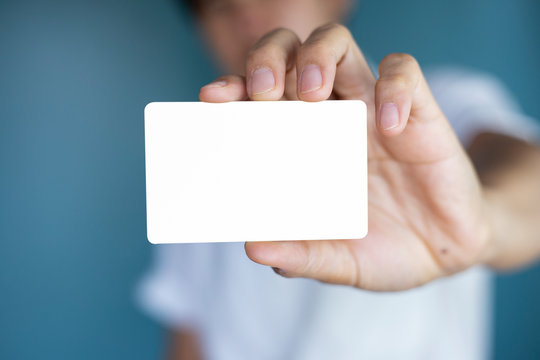 Hand Holding  A Blank Piece Of Paper. Close Up  White Business Card.