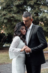 Couple in love - beginning of a love story. A man and a girl in the park. Beautiful pre-wedding photo of the bride and groom. Young couple show love for each other, a holiday