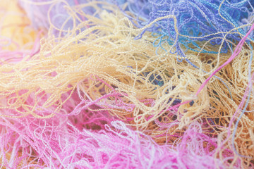 Multi-colored tangled threads abstract texture pattern background. Macro shot of colorful needlecraft silk thread ropes.