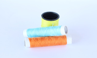 sewing thread over white background