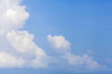 blue sky background with tiny clouds.