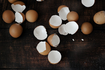broken brown eggs on wooden table background