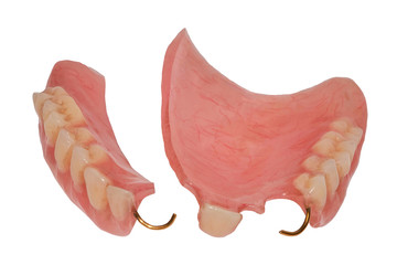 Broken old plastic upper jaw prosthesis with bent clasps. Dental photo Isolated on white