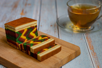 Malaysian dish "Kek Lapis Sarawak" or Sarawak layered cake over wooden background. Similar cake in Indonesia also known as "Kek Lapis Legit" or Legit Layerd Cake.