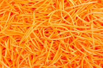 background of carrots cut into thin strips for pickled. korean carrots raw salad
