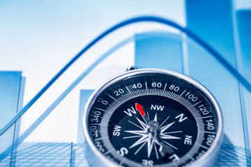 Financial symbols and compass