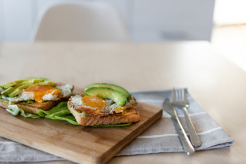 Toast with avocado and fried egg. Healthy breakfast.
