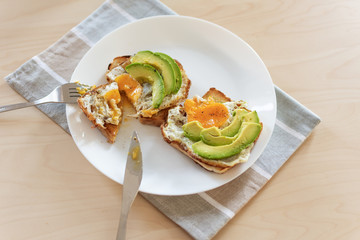Toast with avocado and fried egg. Healthy breakfast.
