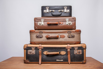 Old, retro, suitcases lie on the table with white background