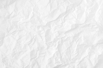 Modern crumpled white paper on empty sheet gray background with light shadows for creative...