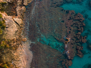 Aerial view of rocks in the sea. Overview of the seabed seen from above, transparent water. Seabed. Pizzo Calabro, Calabria, Italy
