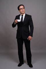 Obraz na płótnie Canvas Full body shot of handsome Persian businessman in suit