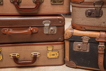 Old, retro, suitcases lie on the table with white background