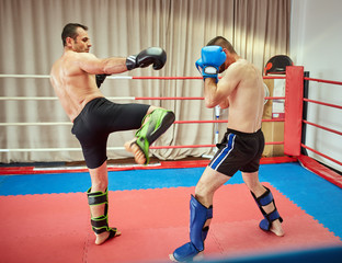Kickboxers sparring in the ring