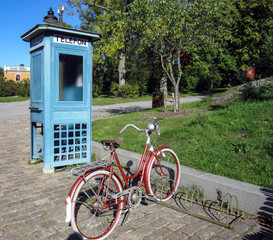 Retro telephone booth and bike - Powered by Adobe