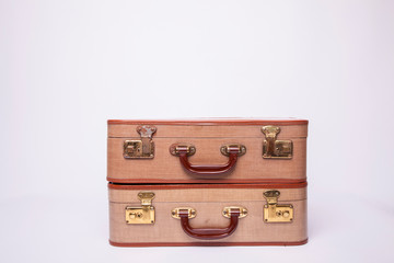 Old, retro, suitcases lie on the table with white background