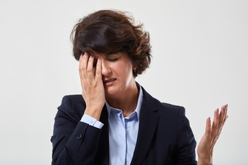 Senior businesswoman with migraine