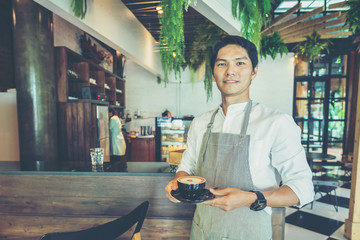 service staff or owner standing in coffee shop