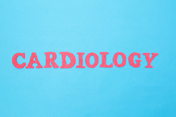 Fototapeta na wymiar Cardiology word in red letters on a blue background. Concept of medicine section dealing with the treatment of heart diseases. Arrhythmia and coronary heart disease.