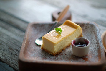 Piece of homemade vanilla cheesecake with blueberry sauce.