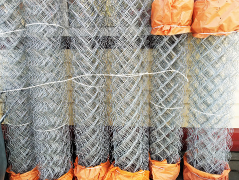 Construction grid a chain-link in rolls. Wicker fence metal bar fence, rabitz