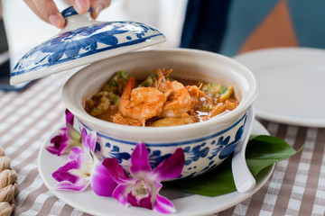 Sour curry Thai soup with Shrimp and Fried Egg, Floral Pattern Cup, Popular menu of Thai people.