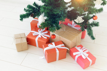 Fototapeta na wymiar Christmas gift boxes and fir tree, top view