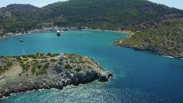 flight over the entrance to the Bay panormitis, the monastery on the old SIM and, view from the drone. Bright sun, a beautiful Bay with the blue water of the sea.