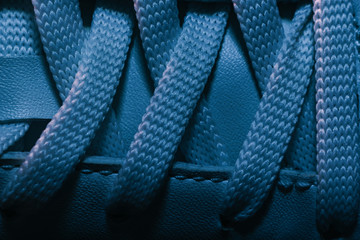 Close up beautiful white shoeloces with color light background texture. Macro photography view.