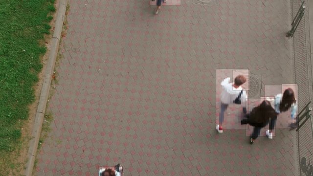 High view camera of people walking. Facial recognition interface scans personal data for each person