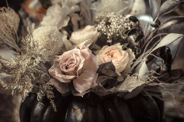 Flower arrangement of fresh flowers in a pumpkin.