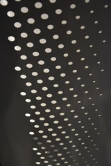 White circles of different sizes on a gray background