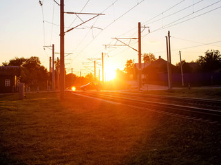 Railroad crossing on which cars ride in the background of the sun. Rail accident concept involving road transport, copy space