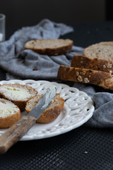 Whole oat sliced bread and fresh butter. Healthy eating concept