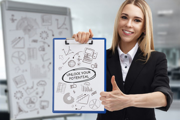 Business, technology, internet and network concept. Young businessman shows a key phrase: Unlock...
