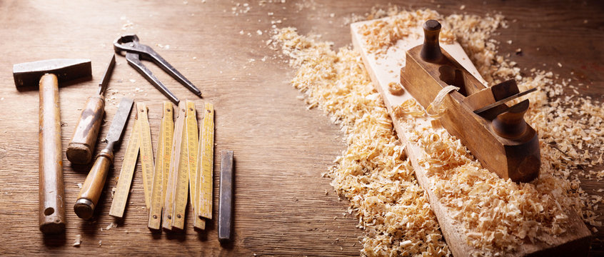old tools: wooden plane, hammer, chisel in a carpentry workshop
